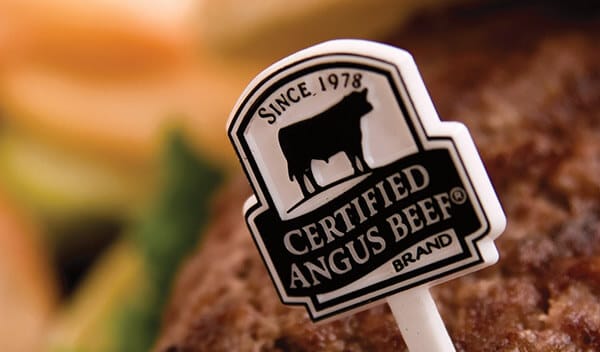 Certified Angus Beef brand marker on a juicy burger patty, highlighting premium beef quality.